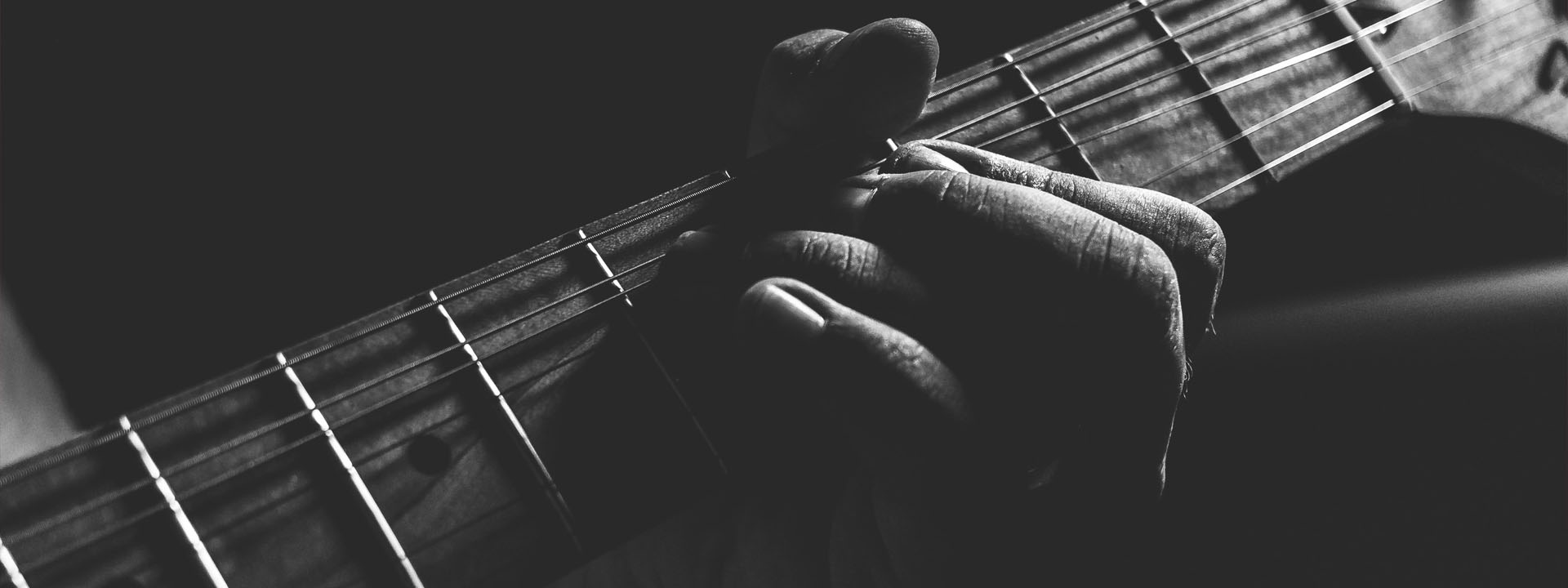 Fingers forming a guitar chord