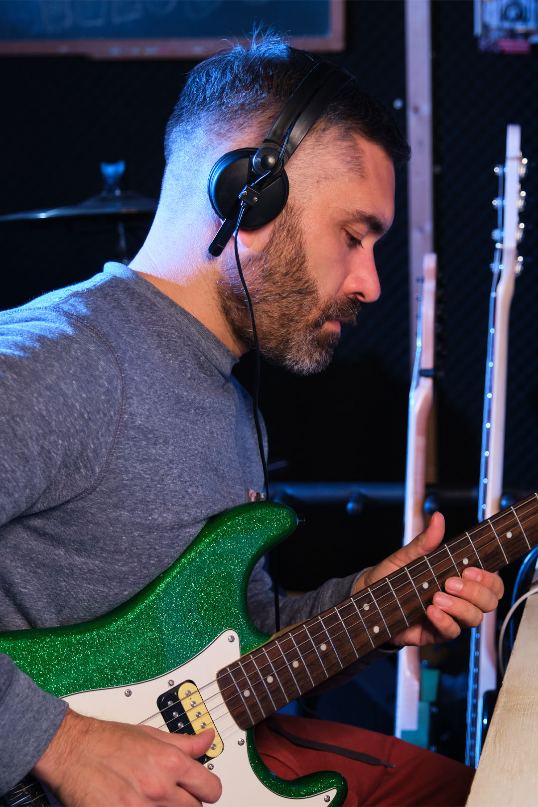 Man learning guitar using Six String Alliance Course
